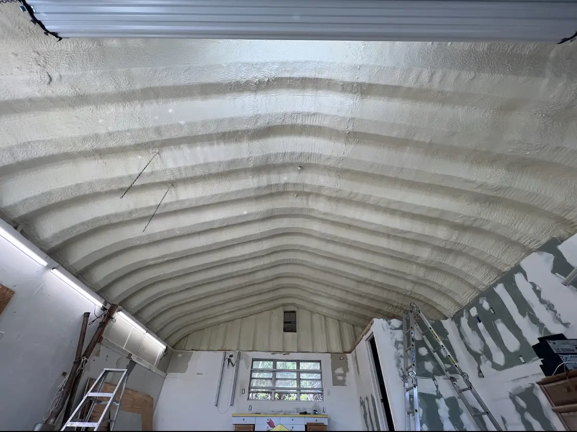 Spray polyurethane foam applied to the underside of a metal roof deck in Red Hill